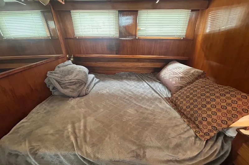 Slide: The Image of Cozy cabin interior of a 1976 Bristol Trawler with wooden walls and a neatly made bed. - 27