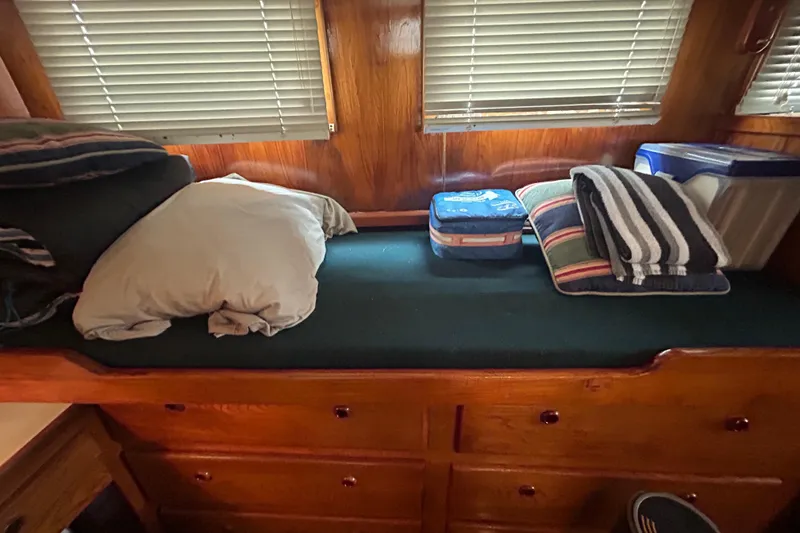 Slide: The Image of Cozy cabin interior of a 1976 Bristol Trawler with bedding and storage. - 31