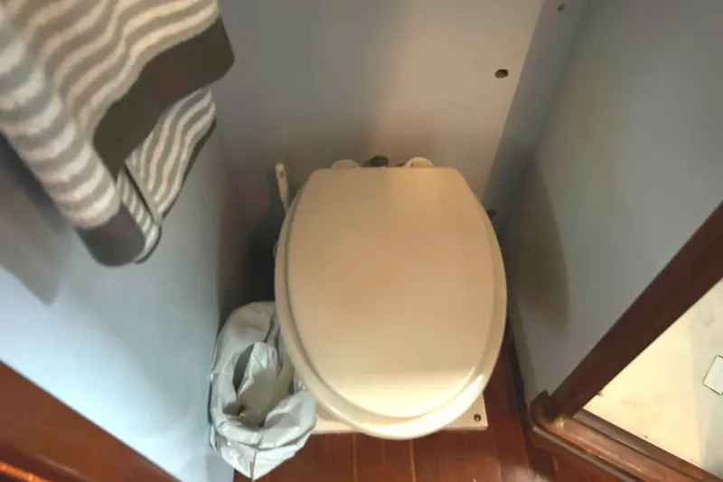 Slide: The Image of 1976 Bristol Trawler bathroom with toilet and striped towel. - 34