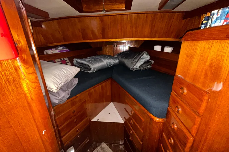 Slide: The Image of Cozy cabin interior of a 1976 Bristol Trawler with wooden furnishings and bedding. - 35