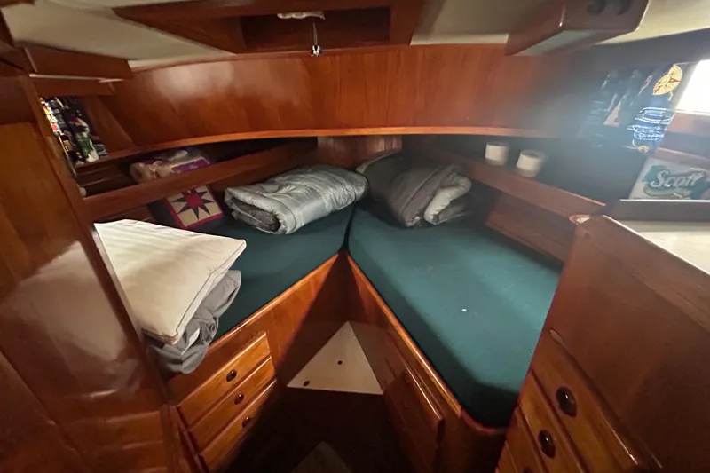 Slide: The Image of Cozy cabin interior of a 1976 Bristol Trawler with wooden finish and twin beds. - 36