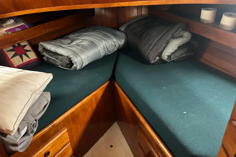 Slide: The Image of Cozy cabin interior of a 1976 Bristol Trawler with bedding and wooden storage. - 37