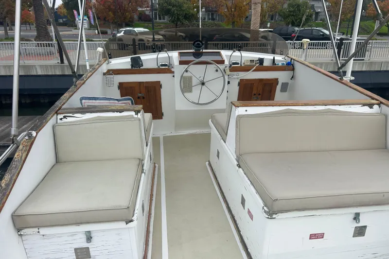 Slide: The Image of 1976 Bristol Trawler boat interior with cushioned seating and steering wheel. - 39