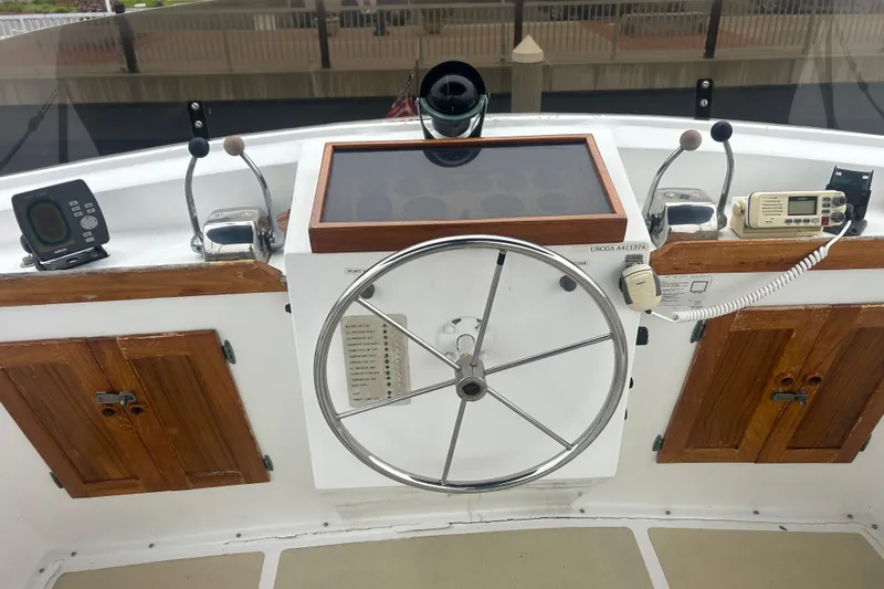 Slide: The Image of 1976 Bristol Trawler helm with steering wheel, navigation instruments, and wooden cabinetry. - 41