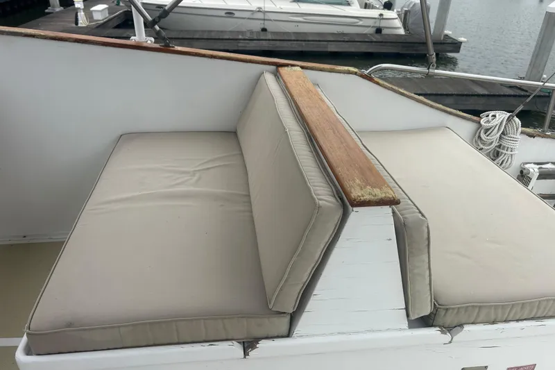 Slide: The Image of 1976 Bristol Trawler boat seating with beige cushions and wooden armrest. - 42
