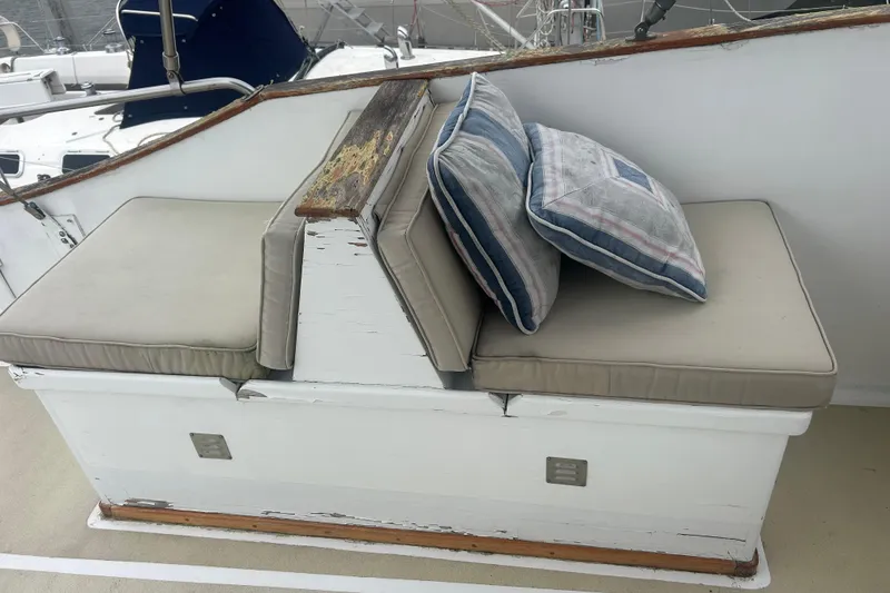 Slide: The Image of Vintage 1976 Bristol Trawler seating with cushions and weathered wood accents. - 43
