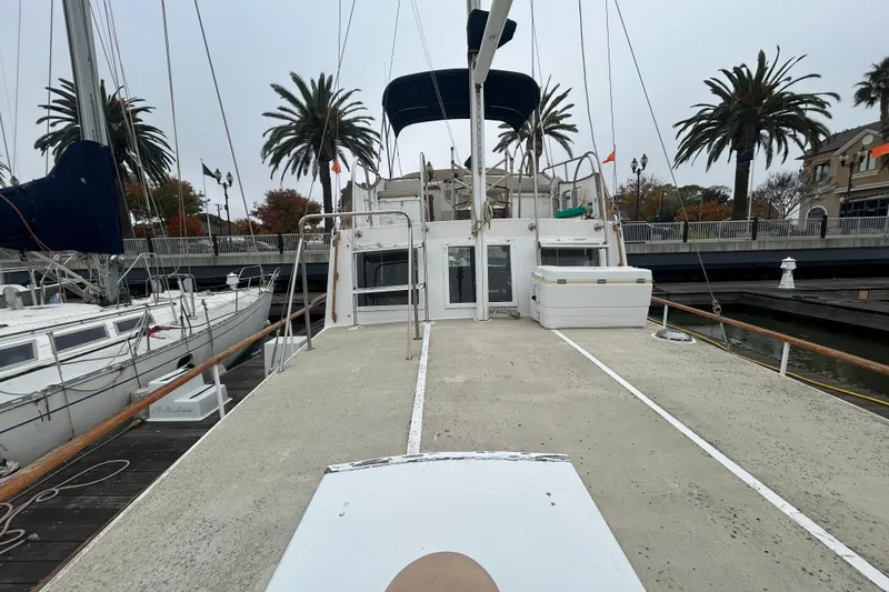 Slide: The Image of 1976 Bristol Trawler docked at marina with palm trees in background. - 46