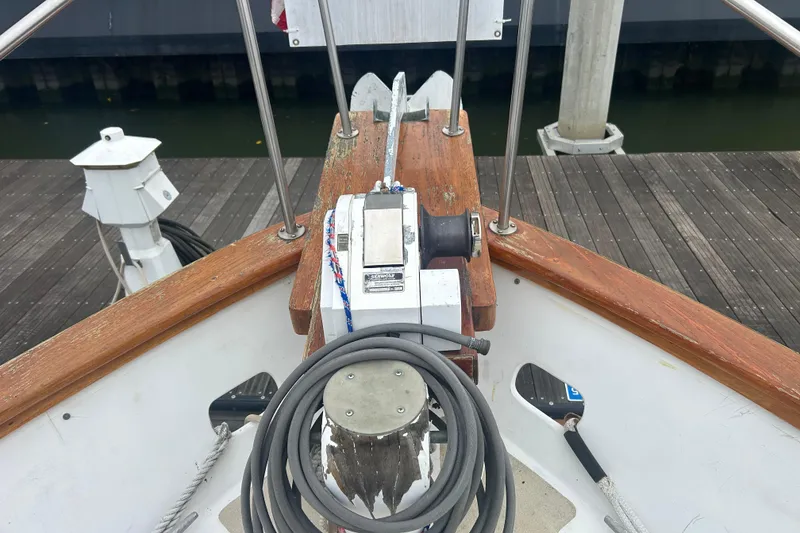 Slide: The Image of 1976 Bristol Trawler bow with anchor winch and coiled rope at dock. - 48
