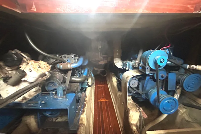 Slide: The Image of Engine room of a 1976 Bristol Trawler, showcasing dual blue marine engines. - 52