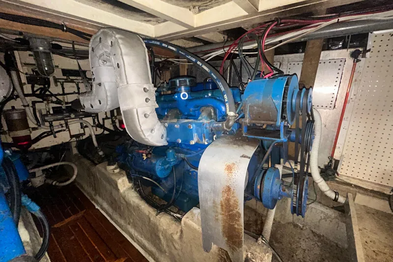 Slide: The Image of Engine room of a 1976 Bristol Trawler, showcasing machinery and wiring. - 53