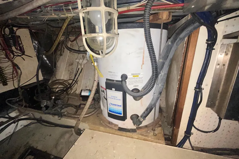 Slide: The Image of 1976 Bristol Trawler engine room with water heater and wiring. - 56