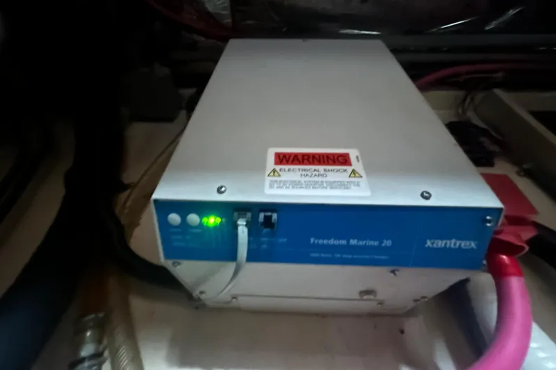 Slide: The Image of Xantrex Freedom Marine 20 inverter in a 1976 Bristol Trawler, with warning label visible. - 58
