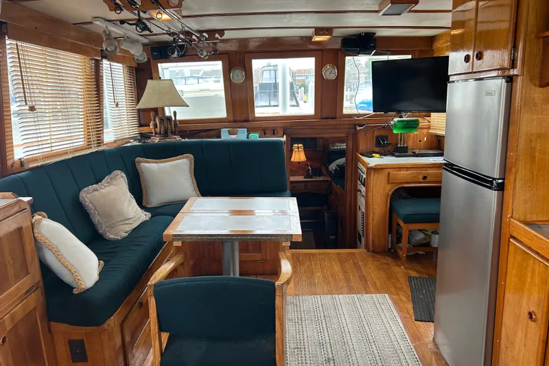 Slide: The Image of 1976 Bristol Trawler interior with wood paneling, cozy seating, and modern amenities. - 7
