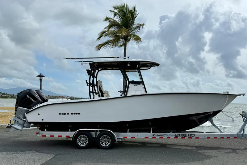 The Image of 2026 Cape Horn 28XS boat on trailer by the ocean, under a cloudy sky. - 1