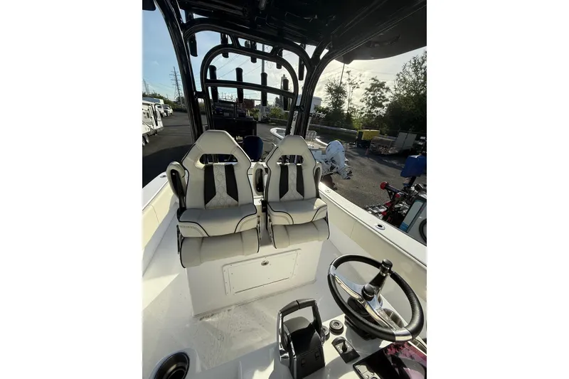 Slide: The Image of 2026 Cape Horn 28XS boat interior with dual seats and steering wheel. - 11