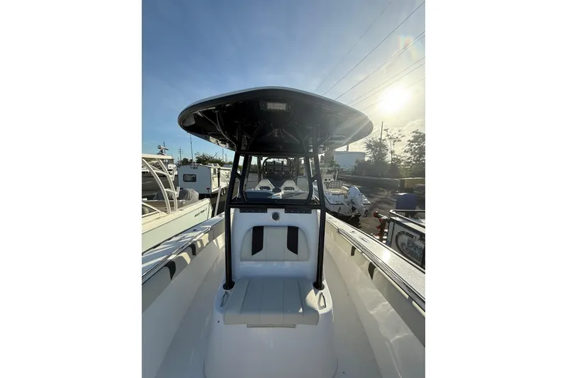 Slide: The Image of 2026 Cape Horn 28XS boat with T-top, docked under clear sky. - 12