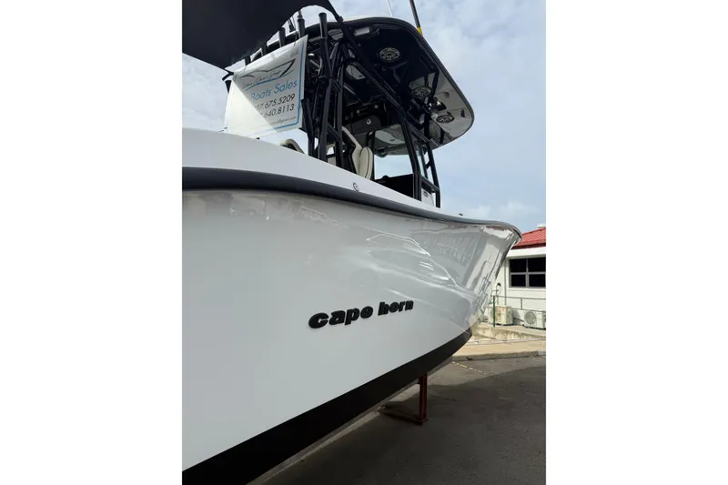 Slide: The Image of 2026 Cape Horn 28XS boat, sleek white hull, docked outdoors. - 7