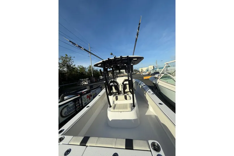 Slide: The Image of 2026 Cape Horn 28XS boat with T-top and seating, docked under clear blue sky. - 9