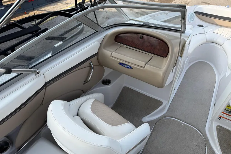 Slide: The Image of 2006 Four Winns 220 Horizon boat interior with beige seating and dashboard. - 9