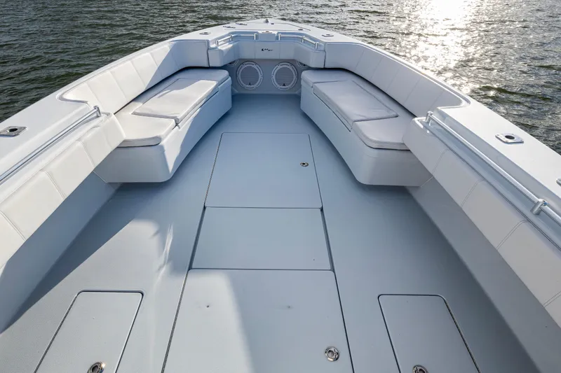 Slide: The Image of 2024 Contender 44 ST boat interior with cushioned seating and ocean view. - 14