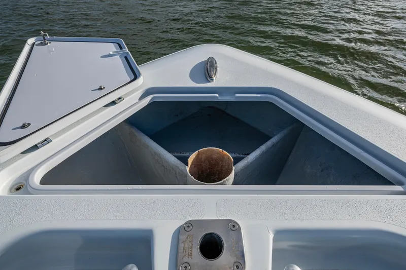 Slide: The Image of Open storage compartment on 2024 Contender 44 ST boat, with water in the background. - 16