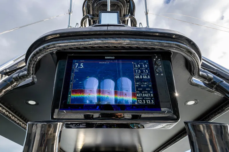 Slide: The Image of 2024 Contender 44 ST boat dashboard with Simrad display showing navigation data. - 24