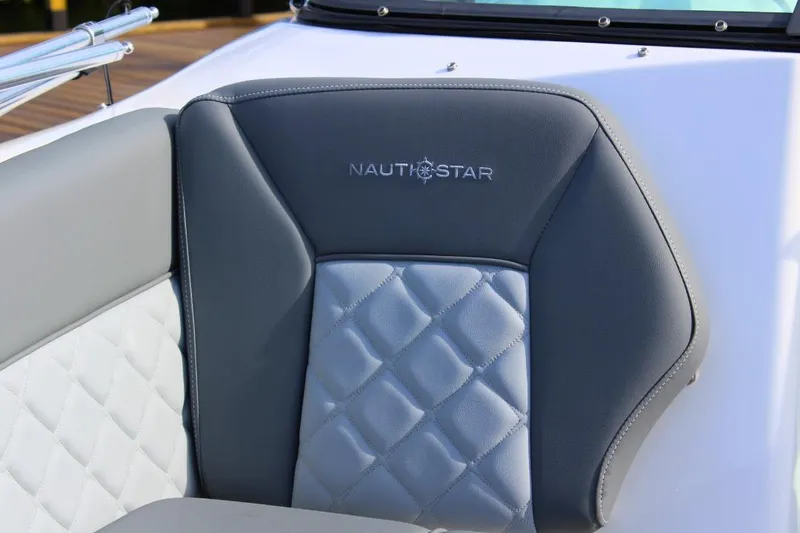 Slide: The Image of 2024 NauticStar 203 DC Deck boat seat with quilted design and logo. - 10