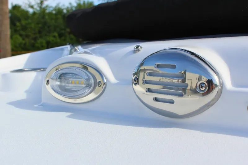 Slide: The Image of 2024 NauticStar 203 DC Deck boat detail with chrome fixtures and LED light. - 11