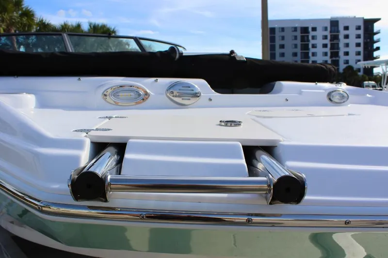 Slide: The Image of 2024 NauticStar 203 DC Deck boat with stainless steel ladder and sleek design. - 12