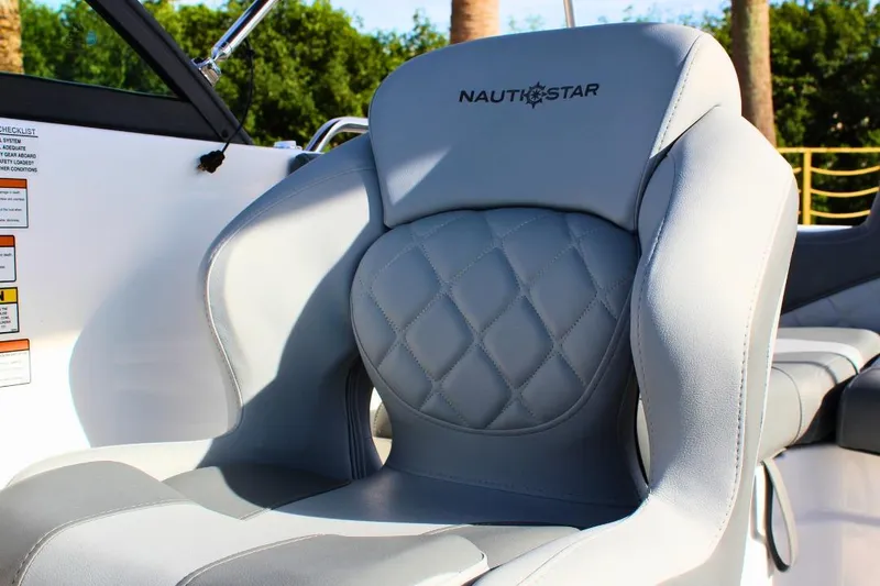 Slide: The Image of 2024 NauticStar 203 DC Deck boat seat with quilted design and logo. - 22
