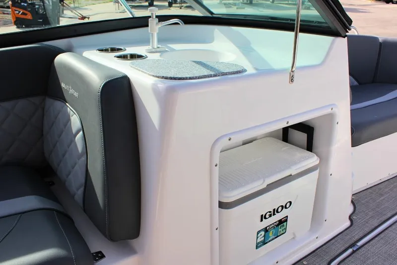 Slide: The Image of 2024 NauticStar 203 DC Deck boat interior with Igloo cooler and seating. - 25