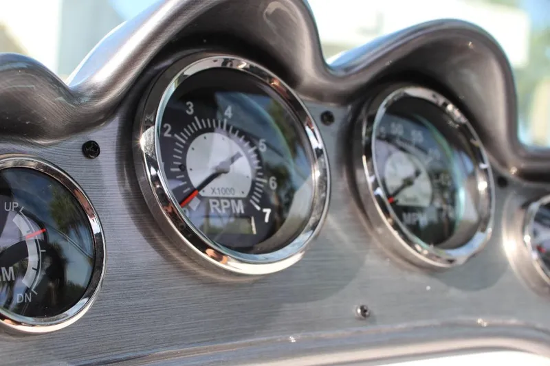 Slide: The Image of Close-up of 2024 NauticStar 203 DC Deck boat dashboard gauges. - 26