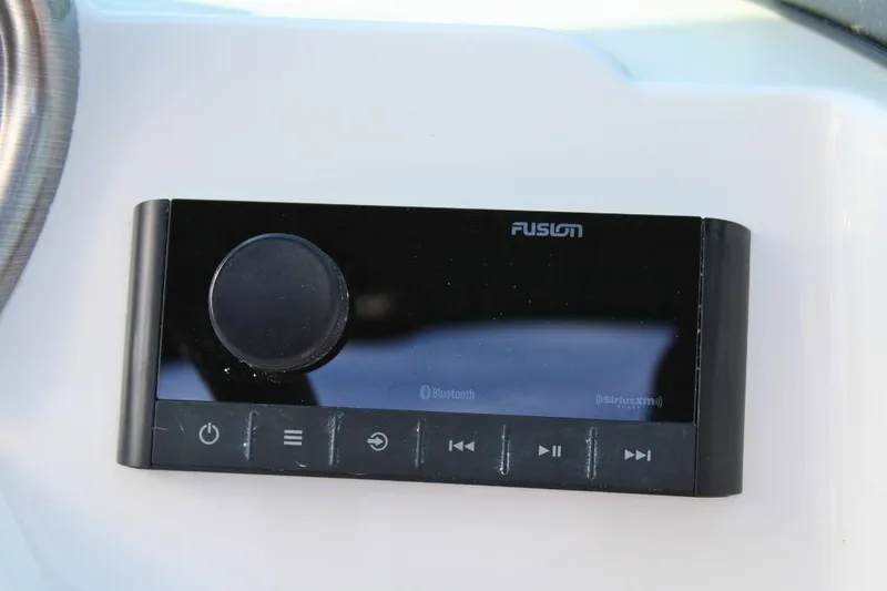Slide: The Image of 2024 NauticStar 203 DC Deck boat audio control panel with Bluetooth and SiriusXM features. - 27