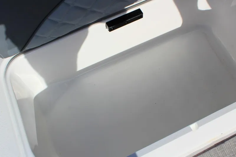Slide: The Image of 2024 NauticStar 203 DC Deck boat storage compartment, open and empty. - 30