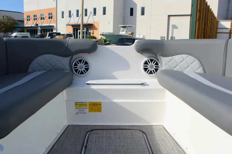 Slide: The Image of 2024 NauticStar 203 DC Deck boat interior with gray seating and speakers. - 31