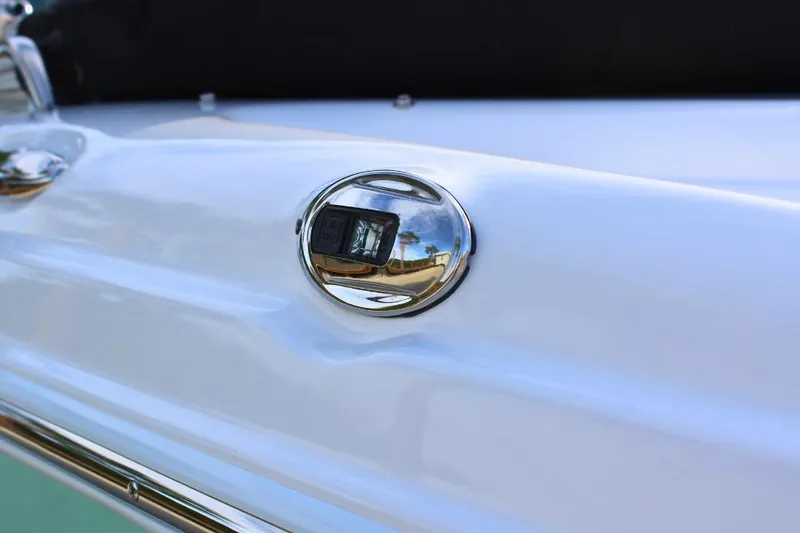 Slide: The Image of 2024 NauticStar 203 DC Deck boat detail with chrome accent and reflection. - 8