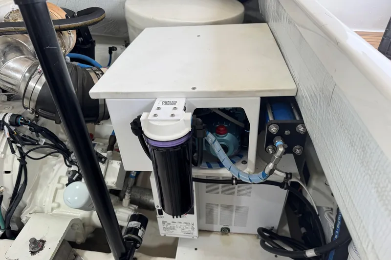 Slide: The Image of Engine compartment of 2022 Tiara Yachts 43 Open, showcasing mechanical components and filtration system. - 11