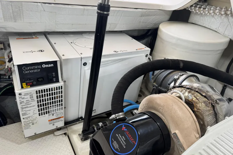 Slide: The Image of Engine room of 2022 Tiara Yachts 43 Open with Cummins Onan generator. - 13