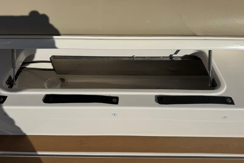 Slide: The Image of Storage compartment on a 2022 Tiara Yachts 43 Open boat, featuring hydraulic supports. - 23