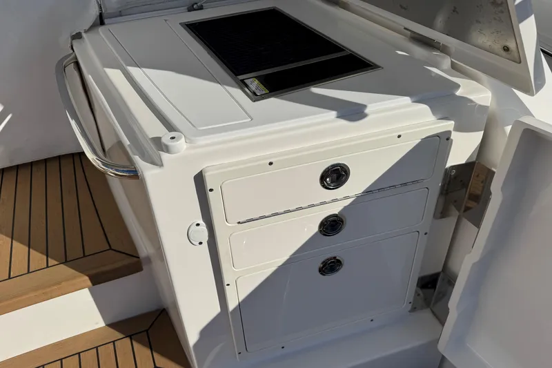 Slide: The Image of 2022 Tiara Yachts 43 Open yacht kitchen area with storage drawers and countertop. - 25