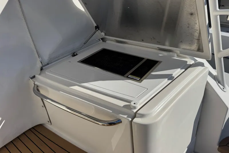 Slide: The Image of Outdoor kitchen area on 2022 Tiara Yachts 43 Open, featuring a built-in grill. - 26