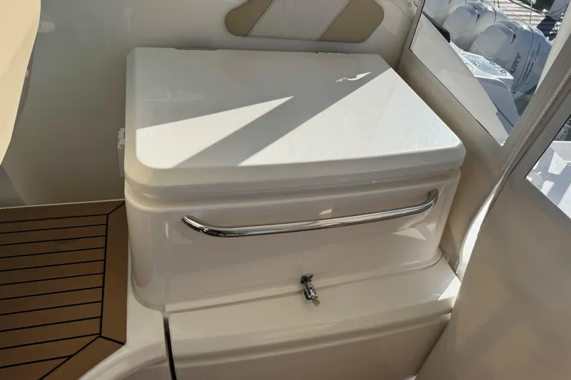 Slide: The Image of 2022 Tiara Yachts 43 Open interior detail with sleek white seating and wooden flooring. - 27