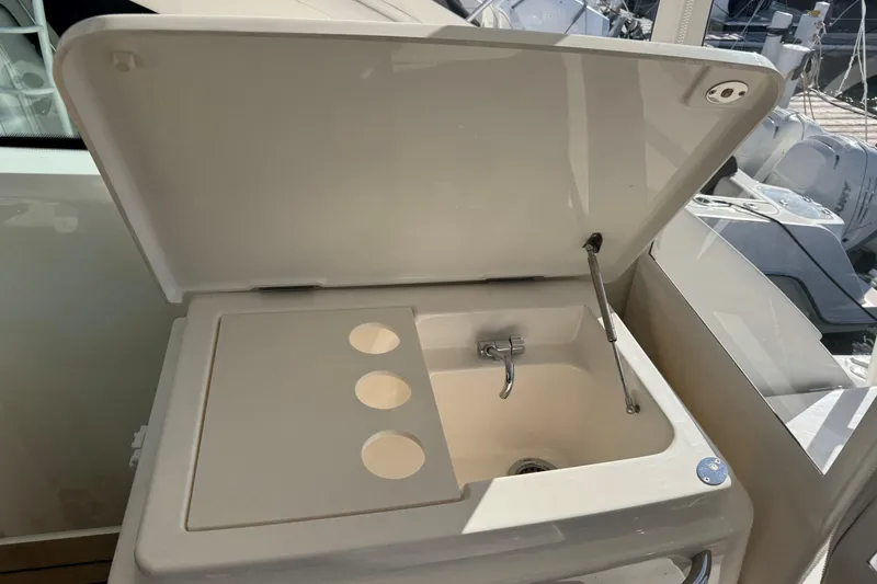 Slide: The Image of 2022 Tiara Yachts 43 Open sink with cover, featuring integrated cup holders. - 28