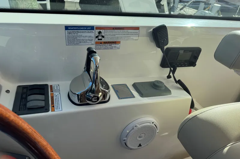 Slide: The Image of Control panel of 2022 Tiara Yachts 43 Open with throttle and communication equipment. - 31