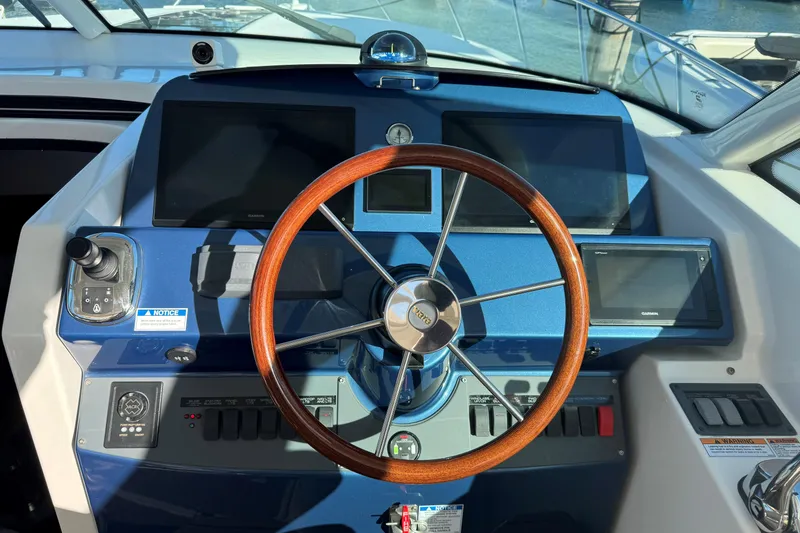 Slide: The Image of Helm of 2022 Tiara Yachts 43 Open with wooden steering wheel and modern controls. - 32