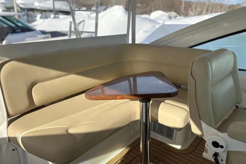 Slide: The Image of Luxurious seating area on 2022 Tiara Yachts 43 Open, featuring beige upholstery and wooden table. - 36
