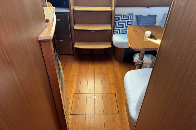Slide: The Image of 2022 Tiara Yachts 43 Open interior with wooden flooring and cozy seating area. - 37