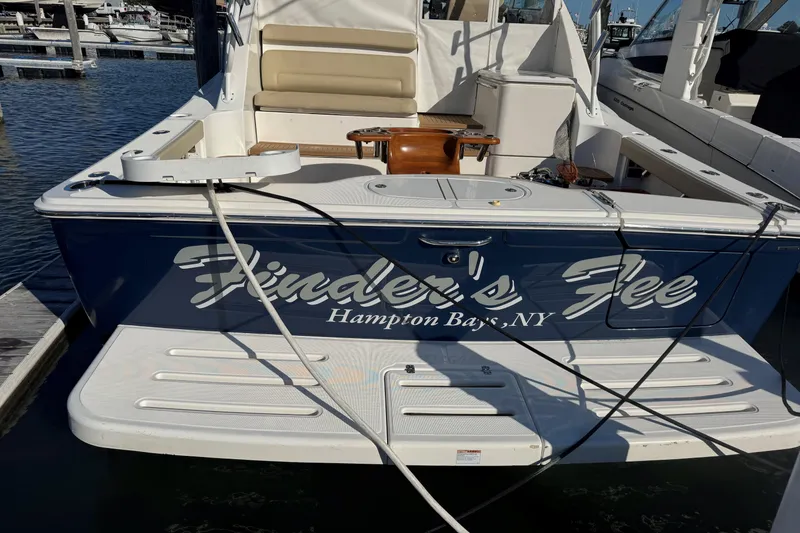 Slide: The Image of 2022 Tiara Yachts 43 Open docked in Hampton Bays, NY, with "Finder's Fee" name. - 4