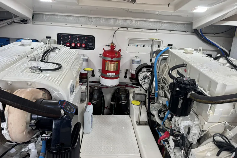 Slide: The Image of Engine room of 2022 Tiara Yachts 43 Open, featuring dual engines and fire extinguisher. - 7