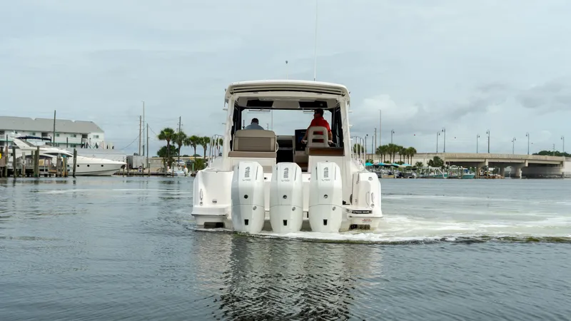 Slide: The Image of 2026 Boston Whaler 365 Conquest on calm waters, rear view. - 2